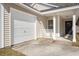 Home exterior featuring a one car garage, front door and covered porch at 228 Two Pond Loop, Ladson, SC 29456