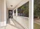 A cozy covered front porch with white railings offers a relaxing outdoor space at 228 Two Pond Loop, Ladson, SC 29456