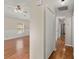 Hallway with wood floors, access to a living area, and multiple white doors at 228 Two Pond Loop, Ladson, SC 29456