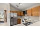 Charming kitchen with stainless steel refrigerator, white appliances and cabinetry at 228 Two Pond Loop, Ladson, SC 29456