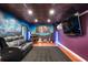 Finished basement with a home theater setup, including guitars and wall art at 2786 Parkers Landing Rd, Mount Pleasant, SC 29466