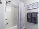 Bathroom with a white tiled shower, grey wall paint, towels and decor at 2786 Parkers Landing Rd, Mount Pleasant, SC 29466