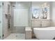 Modern bathroom featuring a luxurious soaking tub and glass shower with rainfall shower head at 2786 Parkers Landing Rd, Mount Pleasant, SC 29466