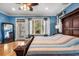 Bright bedroom with blue walls, hardwood floors, and a large wooden bed at 2786 Parkers Landing Rd, Mount Pleasant, SC 29466