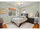 Cozy bedroom with natural light from two windows, featuring a patterned comforter, neutral walls, and wood flooring at 2786 Parkers Landing Rd, Mount Pleasant, SC 29466
