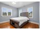 Bedroom features hardwood floors, bright windows, ceiling fan and a rustic bed frame at 2786 Parkers Landing Rd, Mount Pleasant, SC 29466