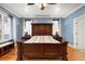Main bedroom with hardwood floors, a striking headboard, and views of the neighborhood at 2786 Parkers Landing Rd, Mount Pleasant, SC 29466