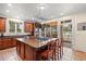 Large kitchen island with granite counters, seating, stainless gas cooktop, and pot rack at 2786 Parkers Landing Rd, Mount Pleasant, SC 29466