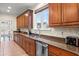 Gourmet kitchen features a large window, stainless appliances, granite counters, and custom wood cabinets at 2786 Parkers Landing Rd, Mount Pleasant, SC 29466