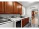 Well-organized laundry room features a sink, folding counter, custom cabinets, and washer and dryer at 2786 Parkers Landing Rd, Mount Pleasant, SC 29466