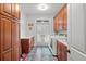 Well-appointed laundry room with built-in cabinets, folding counter, tile floor, and natural light at 2786 Parkers Landing Rd, Mount Pleasant, SC 29466