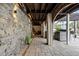 Outdoor stone bar with grill, bar seating, and beautiful stone wall in backyard at 2786 Parkers Landing Rd, Mount Pleasant, SC 29466