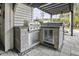 Outdoor kitchen featuring a built-in grill and stainless steel refrigerator at 2786 Parkers Landing Rd, Mount Pleasant, SC 29466