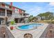 Beautiful pool with a custom patio in the backyard of a two story home with a covered outdoor kitchen and bar at 2786 Parkers Landing Rd, Mount Pleasant, SC 29466