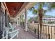 Relaxing covered porch features comfortable seating and scenic views at 2786 Parkers Landing Rd, Mount Pleasant, SC 29466