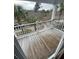 Relaxing outdoor balcony with wood decking and white railings, offering a peaceful view of the surrounding area at 2905 Sweetleaf Ln, Johns Island, SC 29455