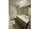 Well-lit bathroom with a double vanity, modern fixtures, and wood-look flooring at 2905 Sweetleaf Ln, Johns Island, SC 29455