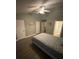 Neutral bedroom with a ceiling fan, wood-look flooring, and multiple closet doors at 2905 Sweetleaf Ln, Johns Island, SC 29455