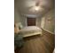 A comfortable bedroom with wood floors, neutral walls, ceiling fan, and a queen size bed at 2905 Sweetleaf Ln, Johns Island, SC 29455