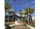 Inviting two-story blue townhome with a charming walkway, white trim, and well-maintained landscaping at 2905 Sweetleaf Ln, Johns Island, SC 29455