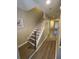 Inviting hallway with a staircase featuring wood-look floors and neutral paint, leading to other rooms at 2905 Sweetleaf Ln, Johns Island, SC 29455