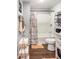 A cozy bathroom with a shower/tub combo, and stylish decor on the walls and shelves at 2916 Marginal Rd, Charleston, SC 29414
