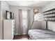 A tidy bedroom featuring a bunk bed, sleek dresser, flat screen TV, and neutral color palette at 2916 Marginal Rd, Charleston, SC 29414