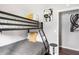 Cozy bedroom featuring a sturdy bunk bed, complete with comfortable gray bedding and decorative pillows at 2916 Marginal Rd, Charleston, SC 29414