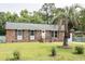 Charming brick home featuring a well-manicured lawn and mature trees at 2916 Marginal Rd, Charleston, SC 29414