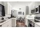 Modern kitchen with white cabinetry, stainless steel appliances, and dining area at 2916 Marginal Rd, Charleston, SC 29414
