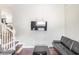 A modern living room featuring a wall-mounted TV, a black coffee table, and a sleek black sofa at 2916 Marginal Rd, Charleston, SC 29414