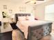 A cozy bedroom featuring a tufted gray bed frame, complemented by soft pastel linens and bright natural lighting at 315 Flyway Rd, Goose Creek, SC 29445