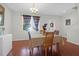 Bright dining area features hardwood floors and an elegant chandelier over a dining table with seating for four at 315 Flyway Rd, Goose Creek, SC 29445