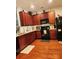 Traditional-style kitchen with dark wood cabinets, granite countertops, and modern appliances at 315 Flyway Rd, Goose Creek, SC 29445