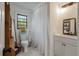 Cozy bathroom with mosaic tile flooring, open shelving, and a white vanity at 3589 Walter Dr, Johns Island, SC 29455