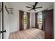 Bright bedroom features hardwood floors, modern ceiling fan and two sunny windows at 3589 Walter Dr, Johns Island, SC 29455