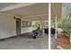 Attached carport, partially shaded, with grey brick and a motorcycle parked inside at 3589 Walter Dr, Johns Island, SC 29455