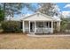 Inviting front porch with white rocking chairs, enhancing the curb appeal of this charming home at 3589 Walter Dr, Johns Island, SC 29455