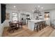 Eat-in kitchen features a large island with seating, stainless appliances, and a wooden dining set at 3589 Walter Dr, Johns Island, SC 29455