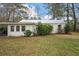 Rear view of home showing rear of property, including carport and grassy yard at 3589 Walter Dr, Johns Island, SC 29455