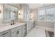 Elegant bathroom with double vanity, marble countertops, and a large mirror at 3794 Sawyers Island Dr, Mount Pleasant, SC 29466