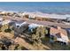 Aerial view of beach houses along the coastline including the main property at 407 Palmetto Blvd, Edisto Beach, SC 29438