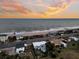 Serene ocean view with beautiful sunset and the listing home perfectly positioned on the beachside street at 407 Palmetto Blvd, Edisto Beach, SC 29438