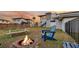 Cozy backyard area with a fire pit, picnic table, and Adirondack chair, perfect for a chill evening at 407 Palmetto Blvd, Edisto Beach, SC 29438
