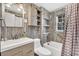 Bathroom featuring modern vanity, tiled shower, and rustic wood-look walls at 407 Palmetto Blvd, Edisto Beach, SC 29438