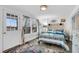 Nautical-themed bedroom with stylish blue and white bedding, an exterior door, and bright natural light at 407 Palmetto Blvd, Edisto Beach, SC 29438