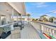 Relaxing covered deck featuring comfortable seating and a coastal breeze in a charming residential neighborhood at 407 Palmetto Blvd, Edisto Beach, SC 29438