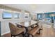 Dining area with large wooden table, wicker chairs, and beach view at 407 Palmetto Blvd, Edisto Beach, SC 29438