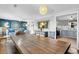 Open concept dining room with large wooden table, seating, and access to the kitchen at 407 Palmetto Blvd, Edisto Beach, SC 29438