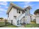 Exterior of the house featuring painted steps and a metal fence at 407 Palmetto Blvd, Edisto Beach, SC 29438